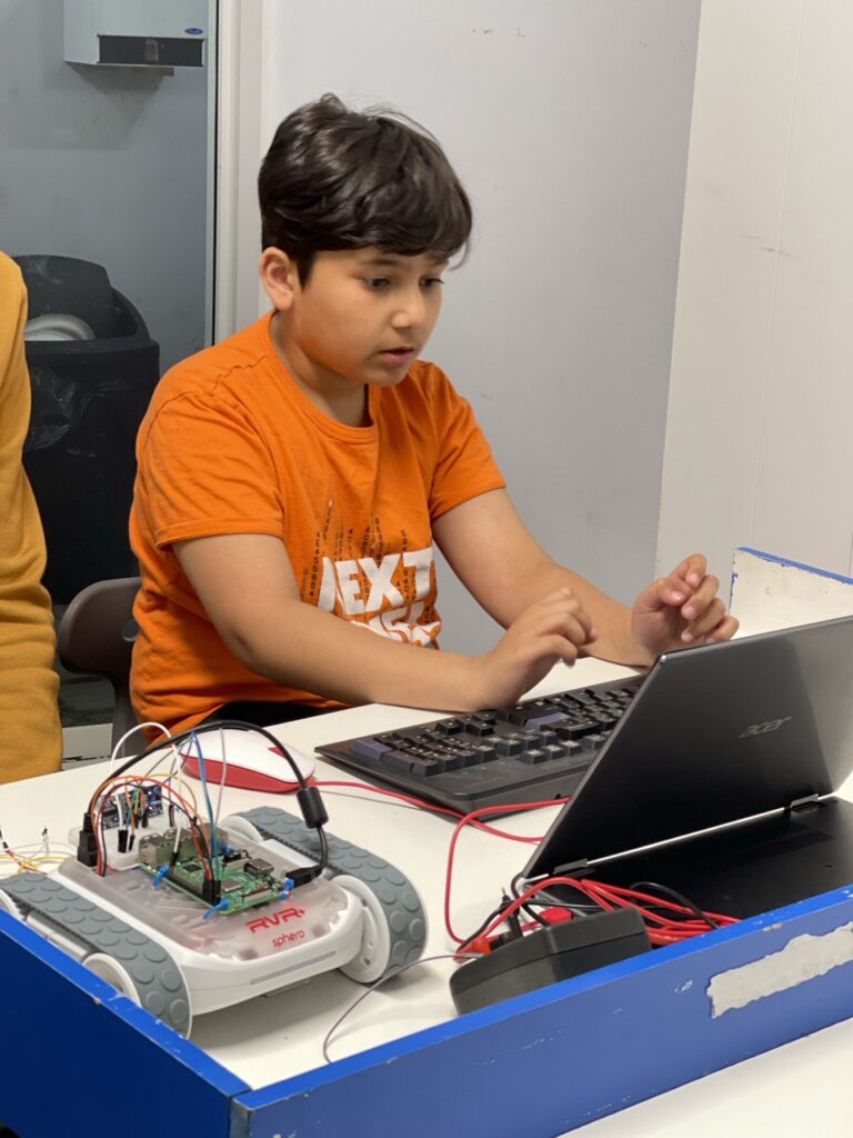 Children taking part in a hands-on Hive5 camp activity in Aurora